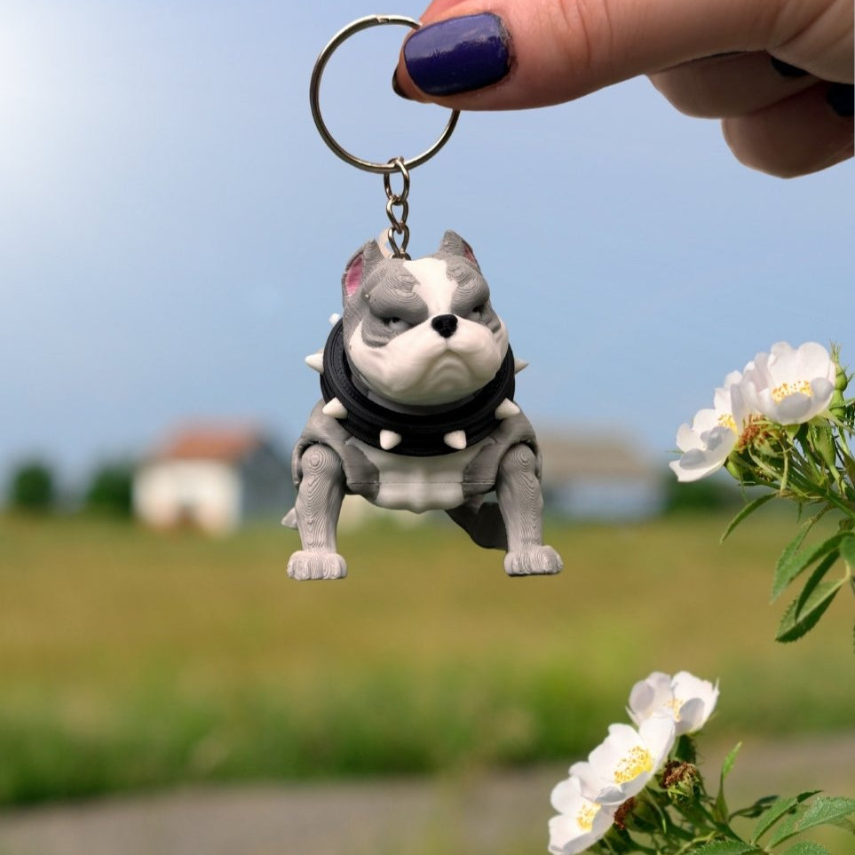 Pitbull and pug keychains attached to the same keyring, highlighting their complementary styles. A great choice for dog lovers.