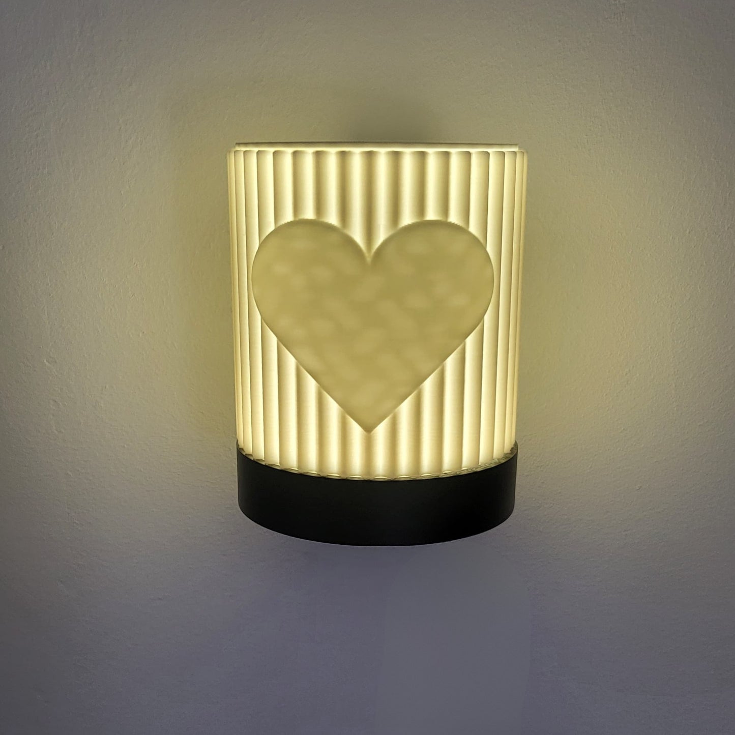 Wall lamp with a heart design on a textured surface
