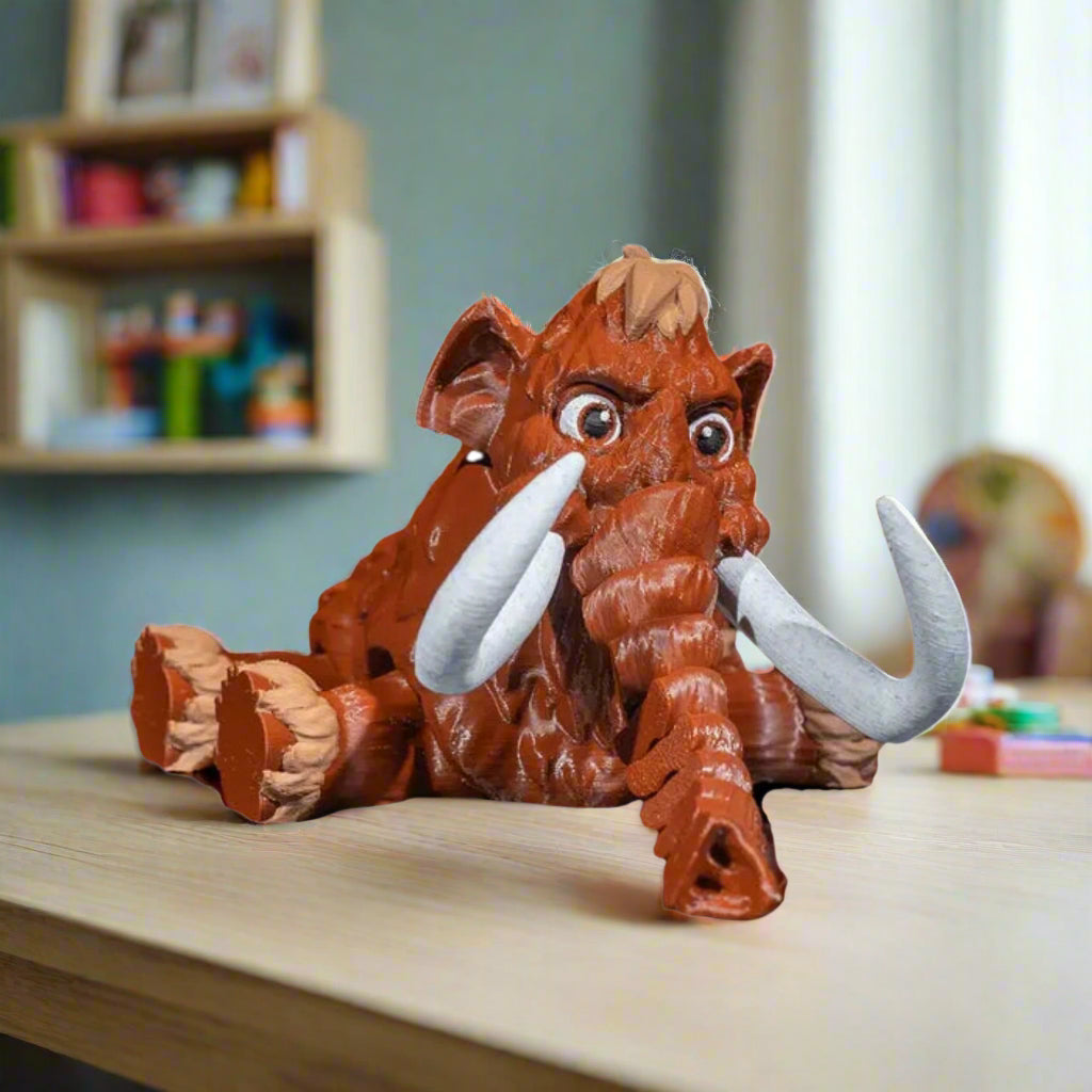 Toy figure of a stylized mammoth on a white background