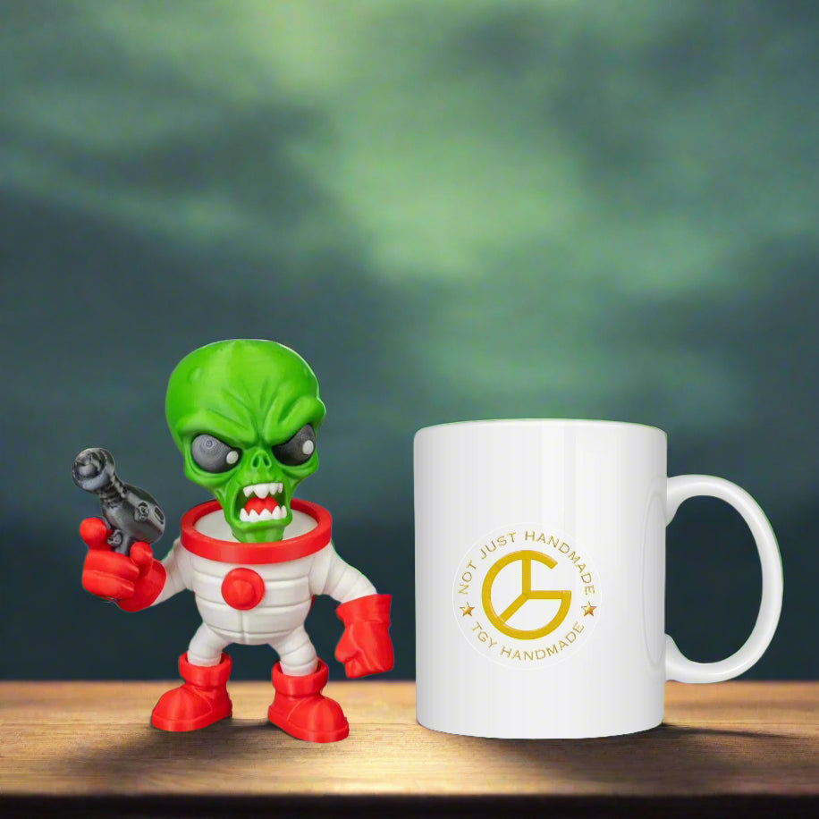 Toy figure holding a small robot next to a mug with a logo on a wooden surface