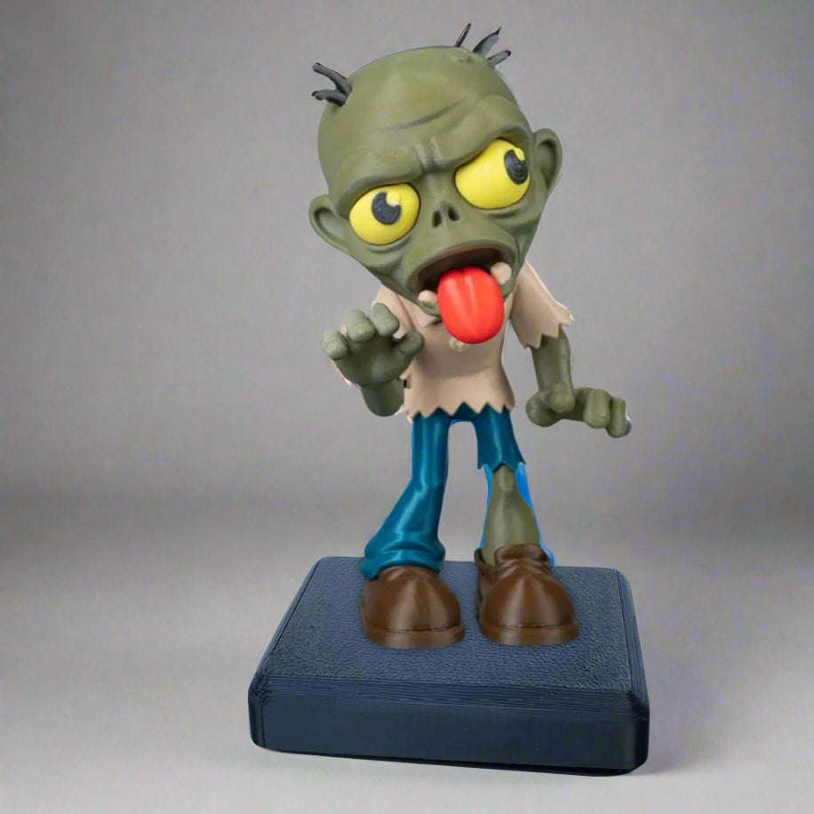 Toy figure of a zombie with a red tongue on a gray background