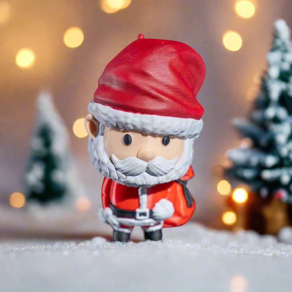 Small Santa Claus figurine with a red hat and coat on a white background