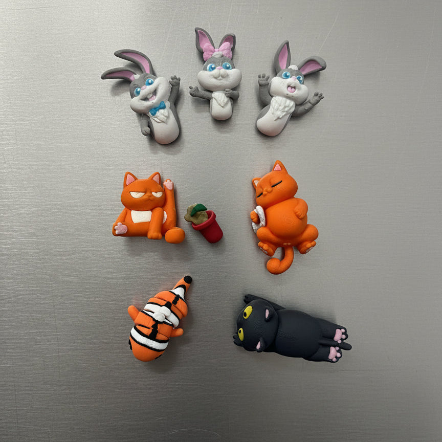 Set of cartoon character magnets on a metallic surface