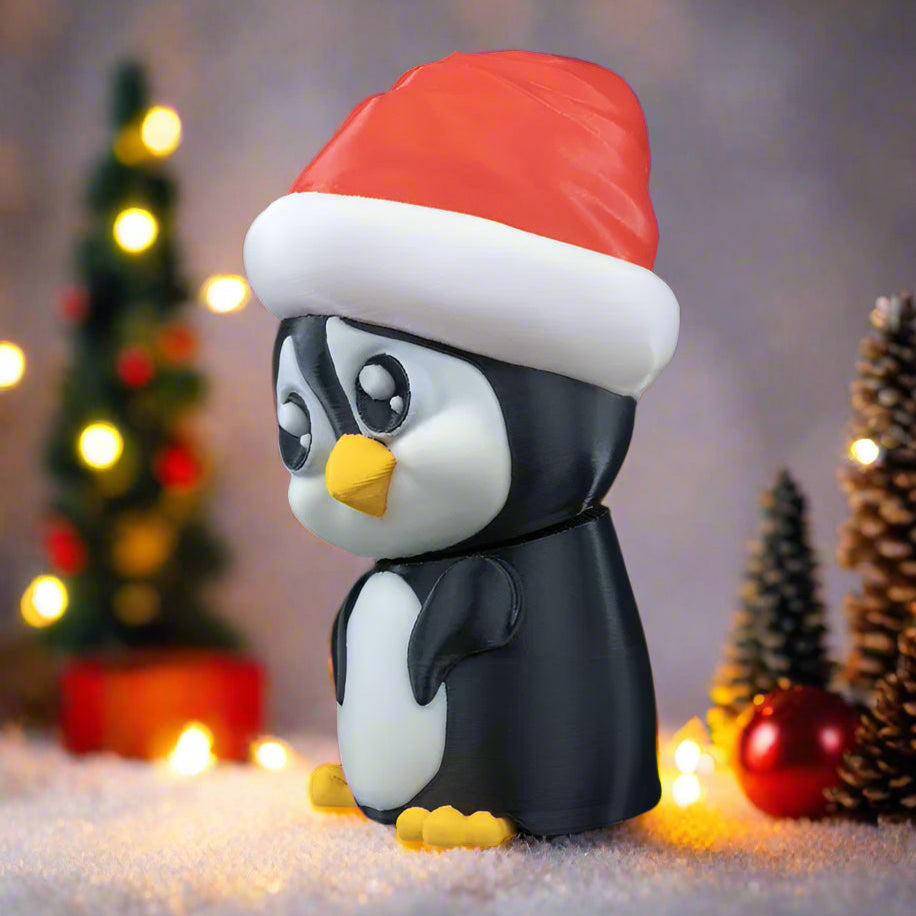 Penguin figurine wearing a Santa hat with Christmas decorations in the background