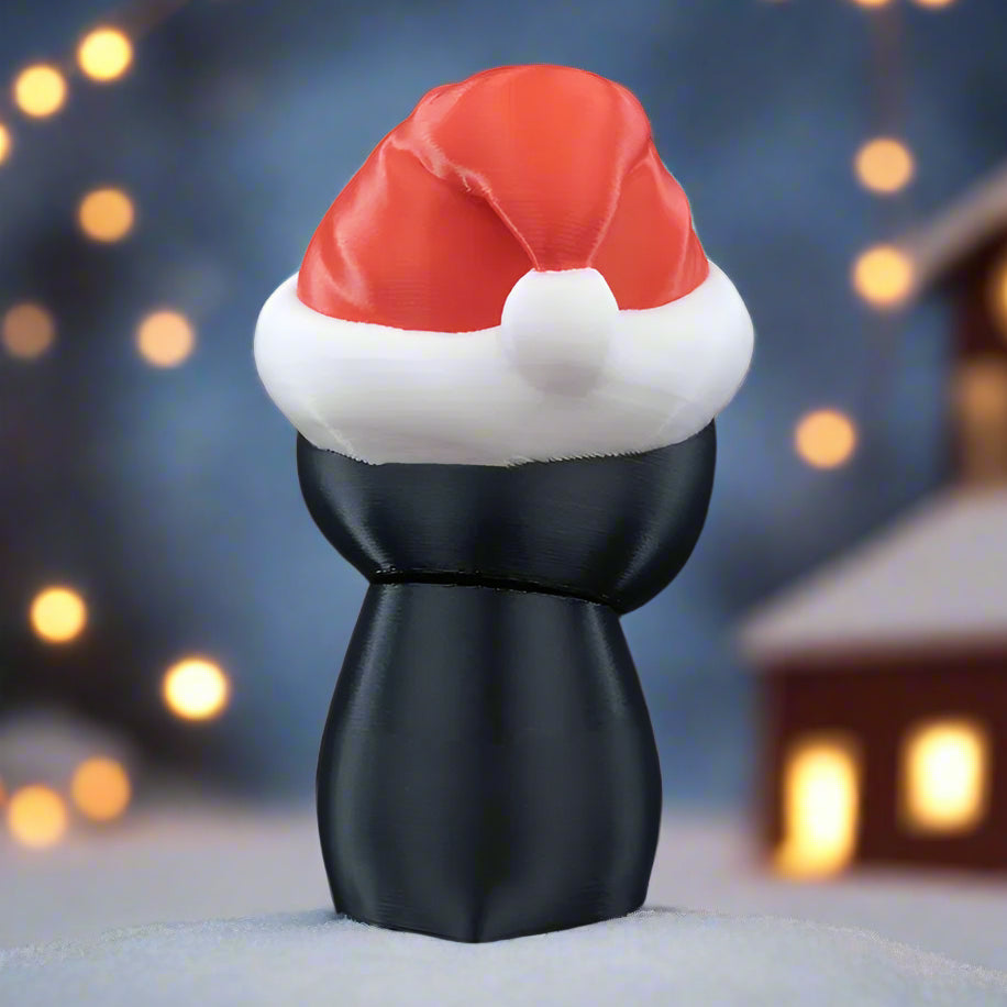 Black figure wearing a red Santa hat on a black background