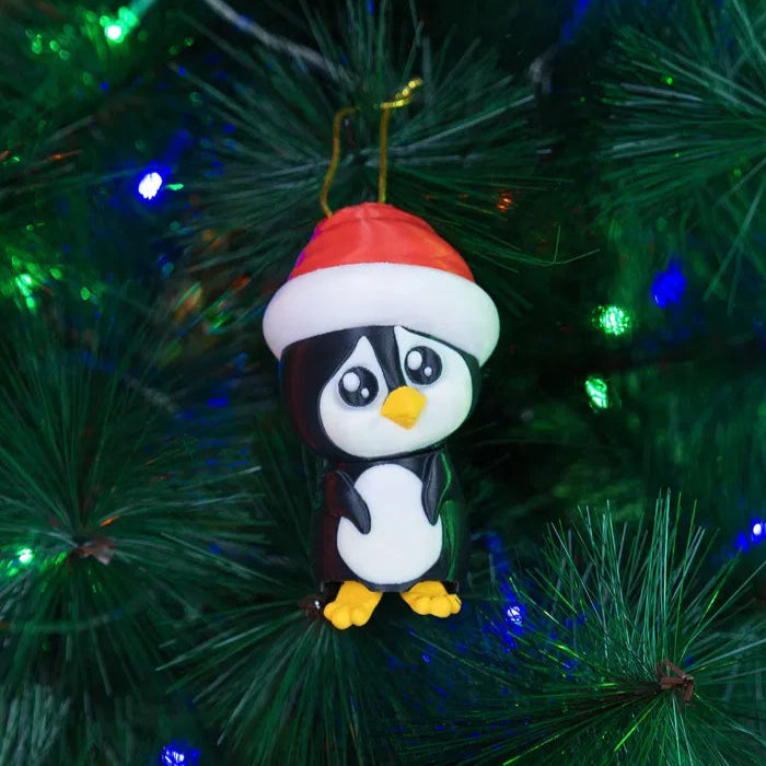 Penguin ornament with a Santa hat on a Christmas tree