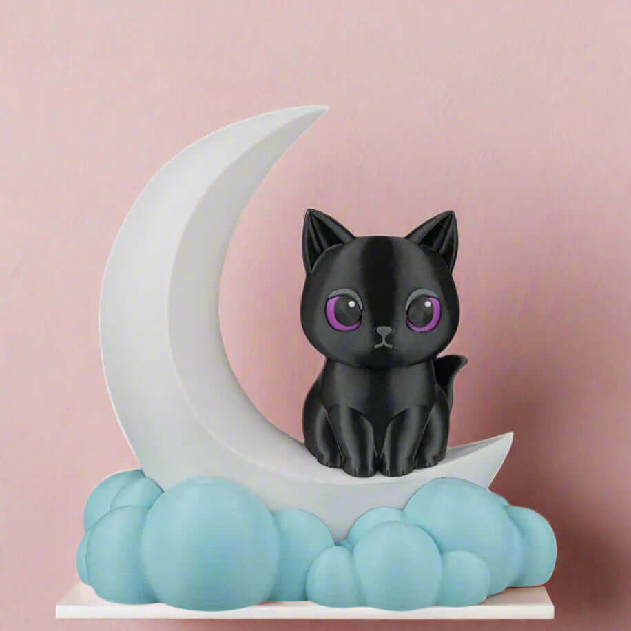Black cat figurine on a white crescent moon with blue clouds against a pink background