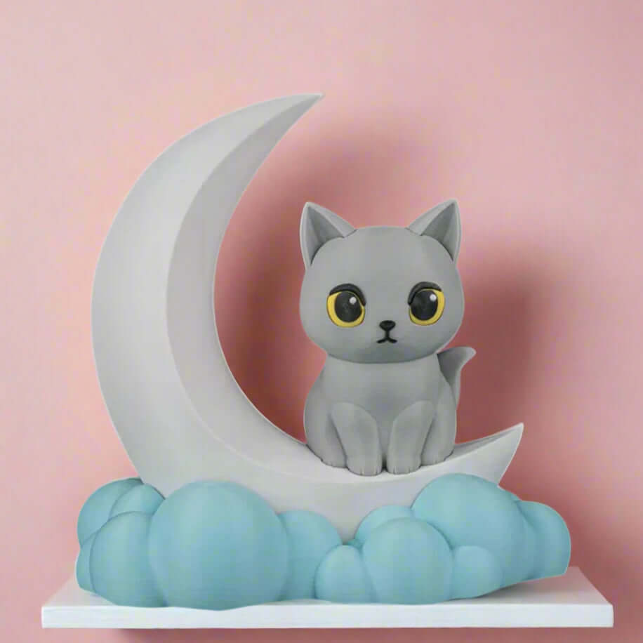 Cat figurine on a crescent moon with clouds below on a white background