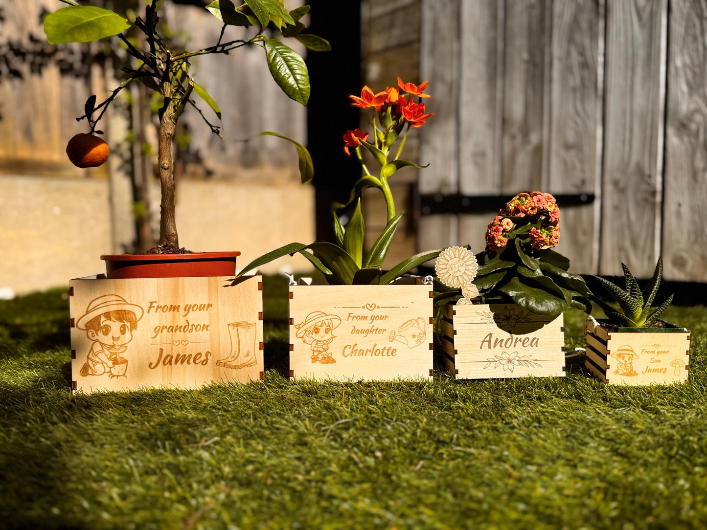 The wooden pot is shown hanging from a garden fence, surrounded by blooming flowers and greenery. Its compact design and durable rope make it ideal for outdoor or balcony use. A trailing plant spills gently over the edges, enhancing the rustic aesthetic. The engraved name on the front adds a personal touch. This setting demonstrates how easily the planter adds charm to outdoor decor or small garden spaces.