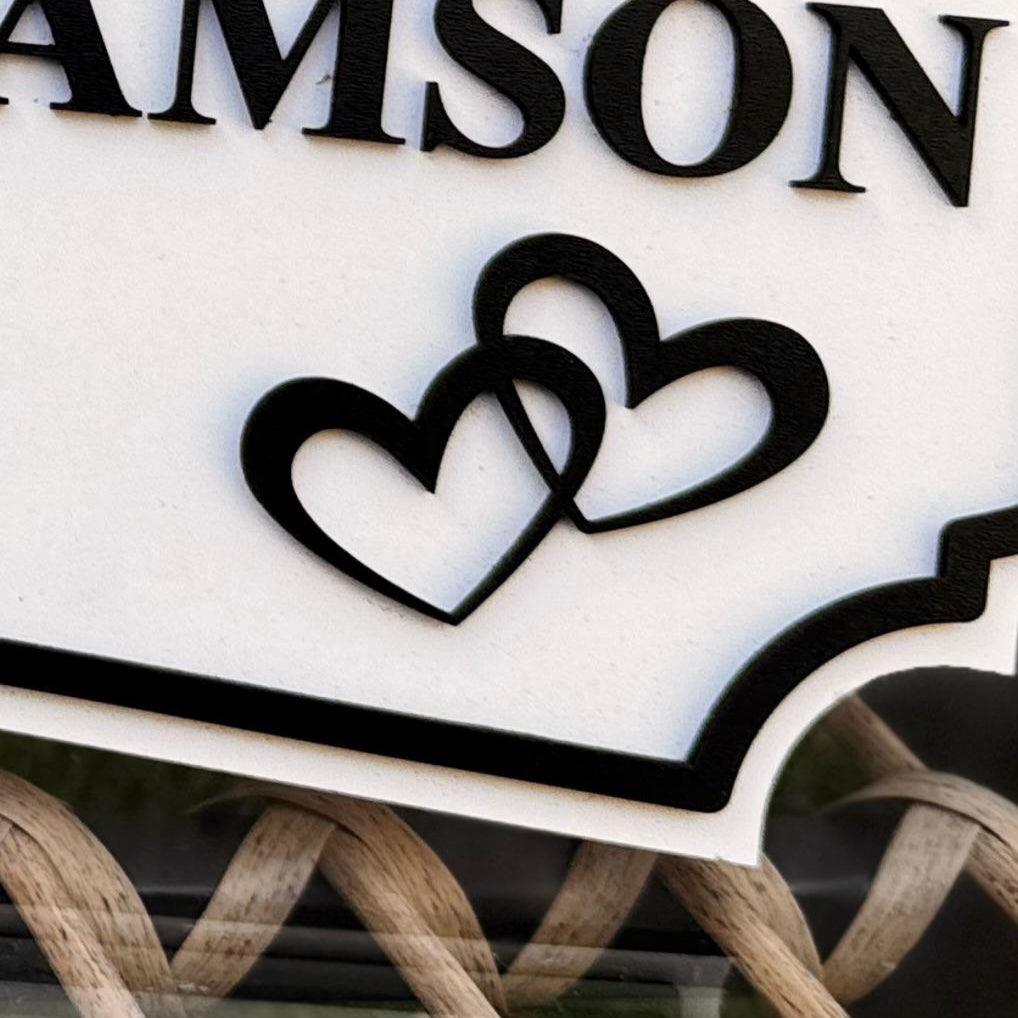 Decorative sign with 'MR & MRS WILLIAMSON' and date on a metal surface.