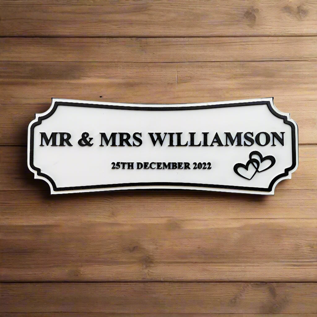 Decorative sign with 'MR & MRS WILLIAMSON' and date on a gray background