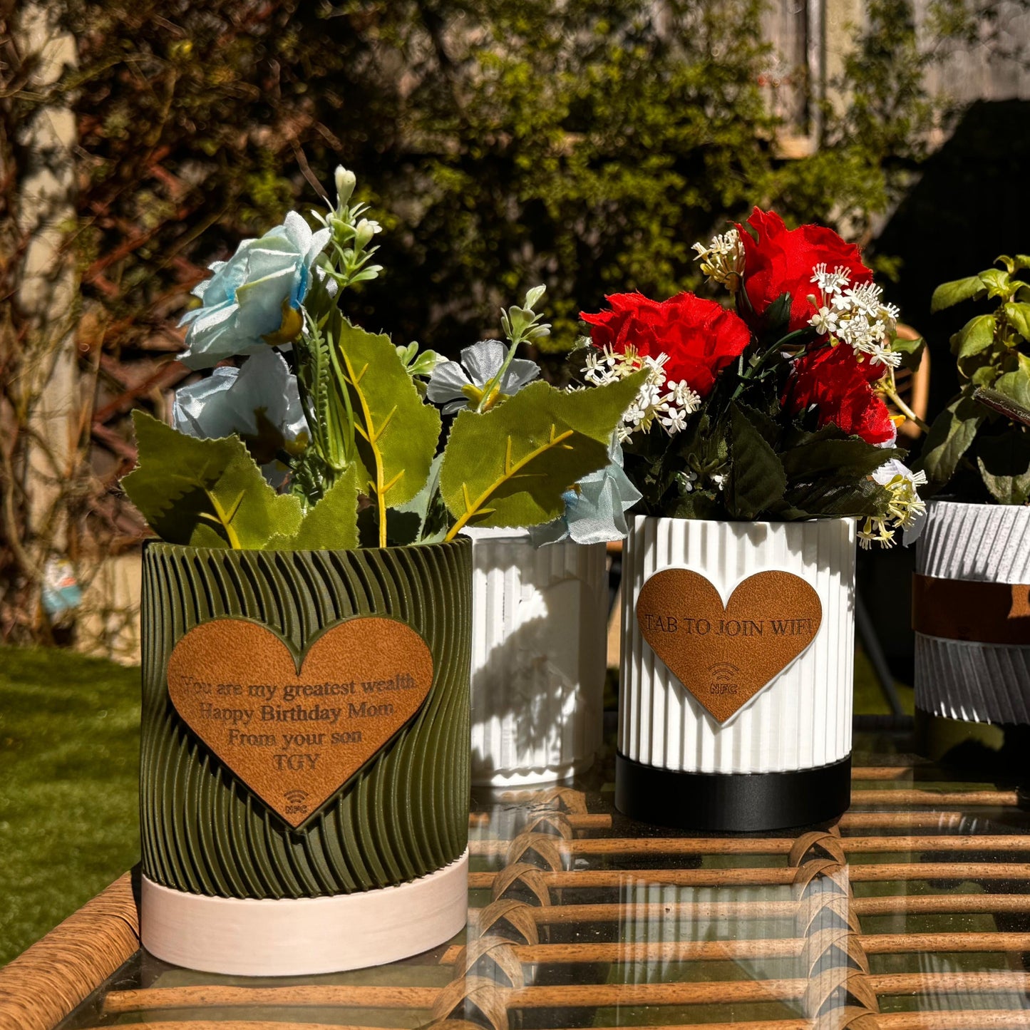 ultiple engraved pots displayed on a shelf with varied messages
An arrangement of several personalized flowerpots on a wooden shelf, each engraved with different heartfelt messages such as “Thank You,” “Grow Together,” and “Love Blooms Here.” The variety showcases the customization options and makes the display visually appealing, ideal for group gifting or themed home decor.