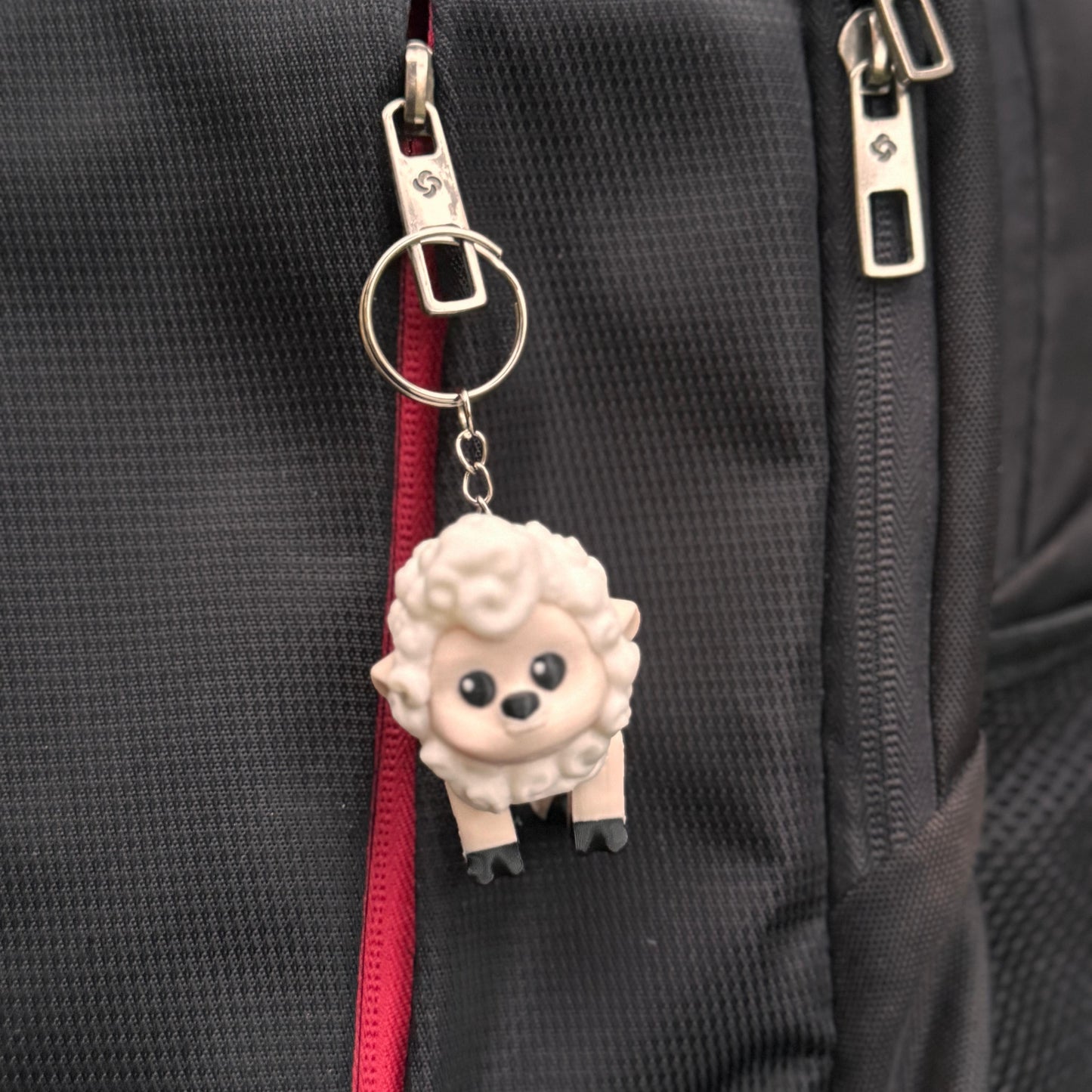 Side view of the sheep keychain with fluffy wool texture and rounded body. The soft, smiling design makes it a great gift for kids or farm animal fans.