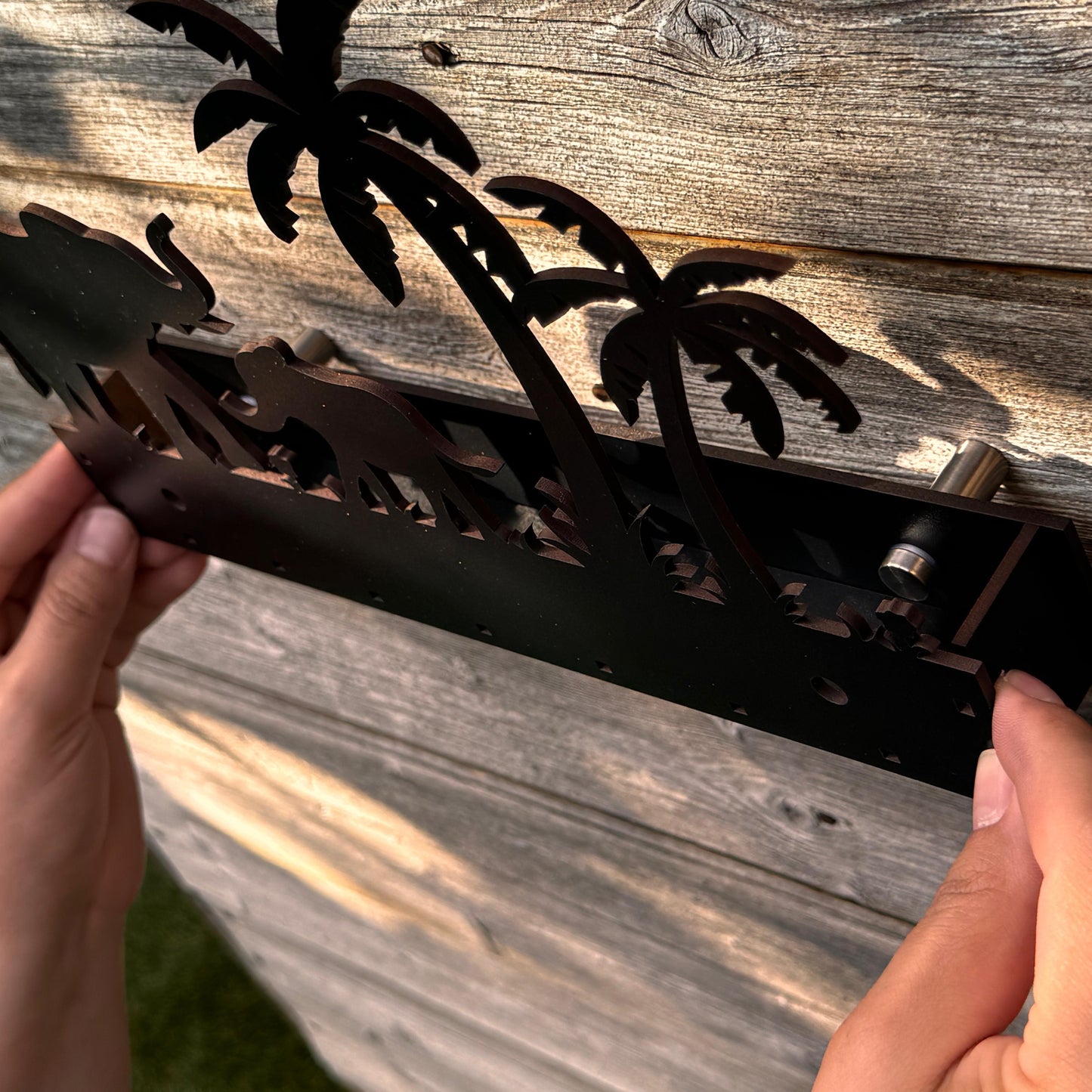 Black wooden wall sign placed in a Scandinavian-style modern interior, acting as a decorative element in a living space or home office.
