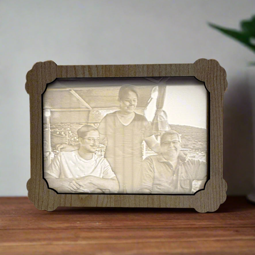 Wooden photo frame with a vintage family portrait inside, placed on a wooden surface.
