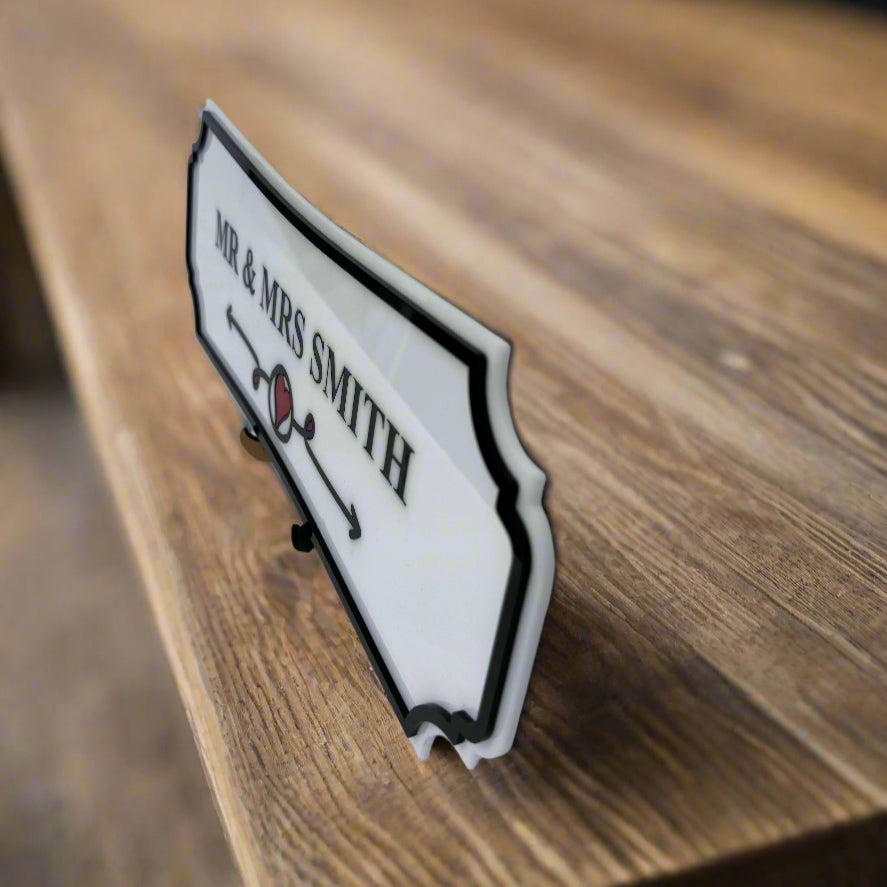Decorative sign with 'Mr & Mrs Smith' on a wooden surface