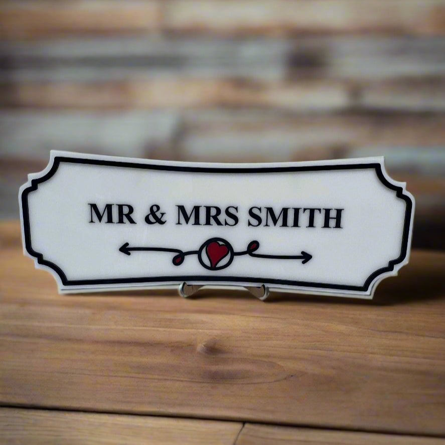 Decorative sign with 'MR & MRS SMITH' on a wooden surface