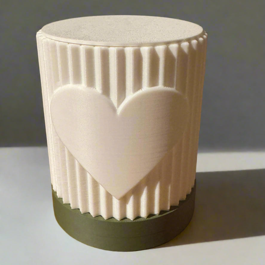 White ceramic mug with a heart design on a wooden surface