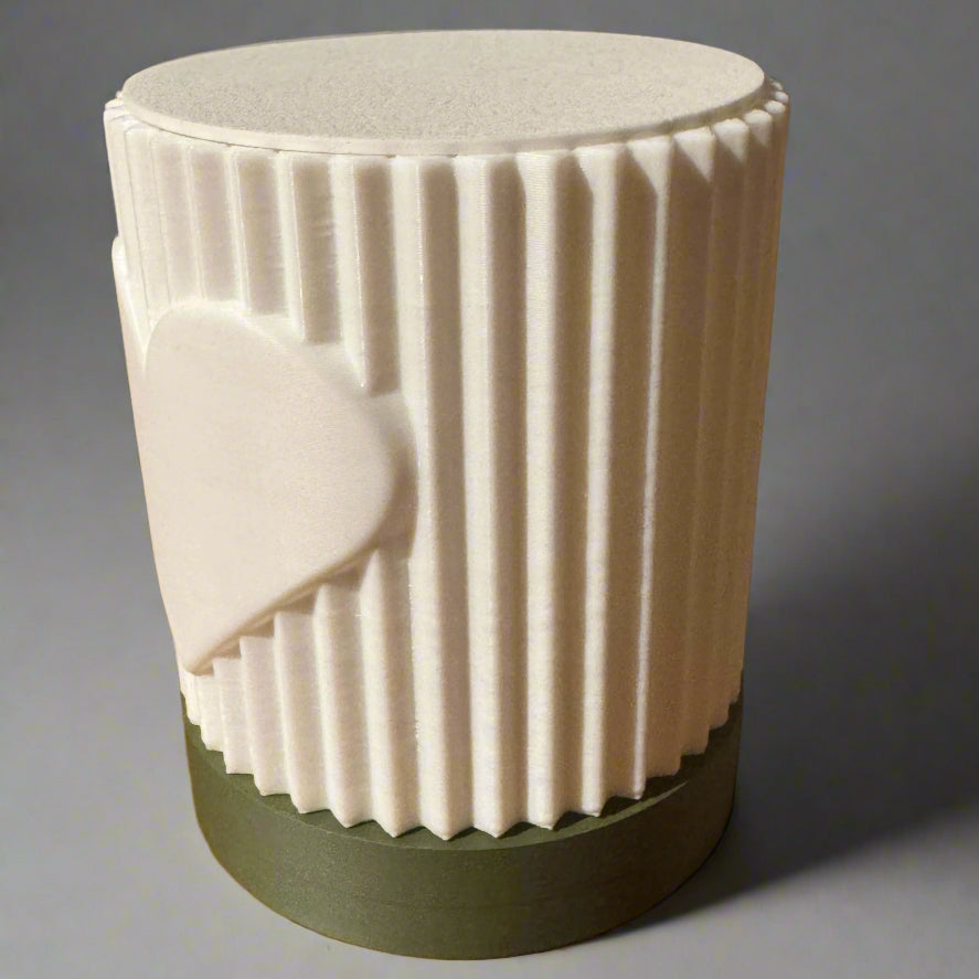 White textured lamp with green base on a wooden surface