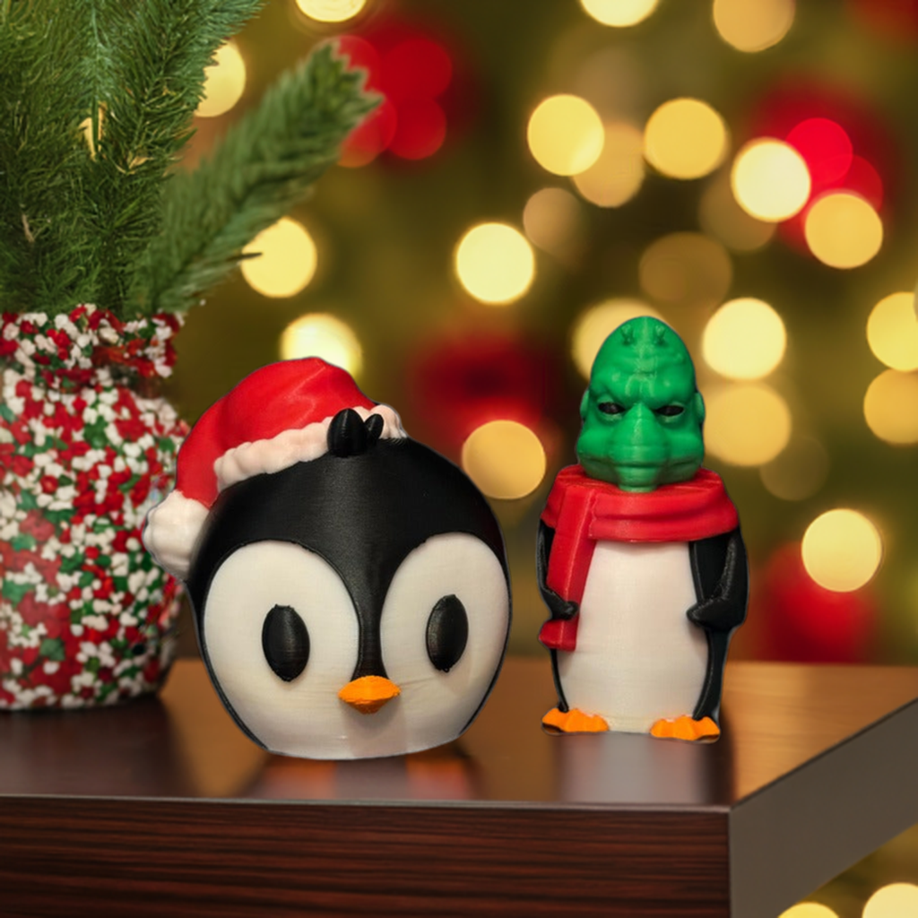 A whimsical holiday decoration featuring a penguin with a removable green alien head, posed in front of a Christmas tree.