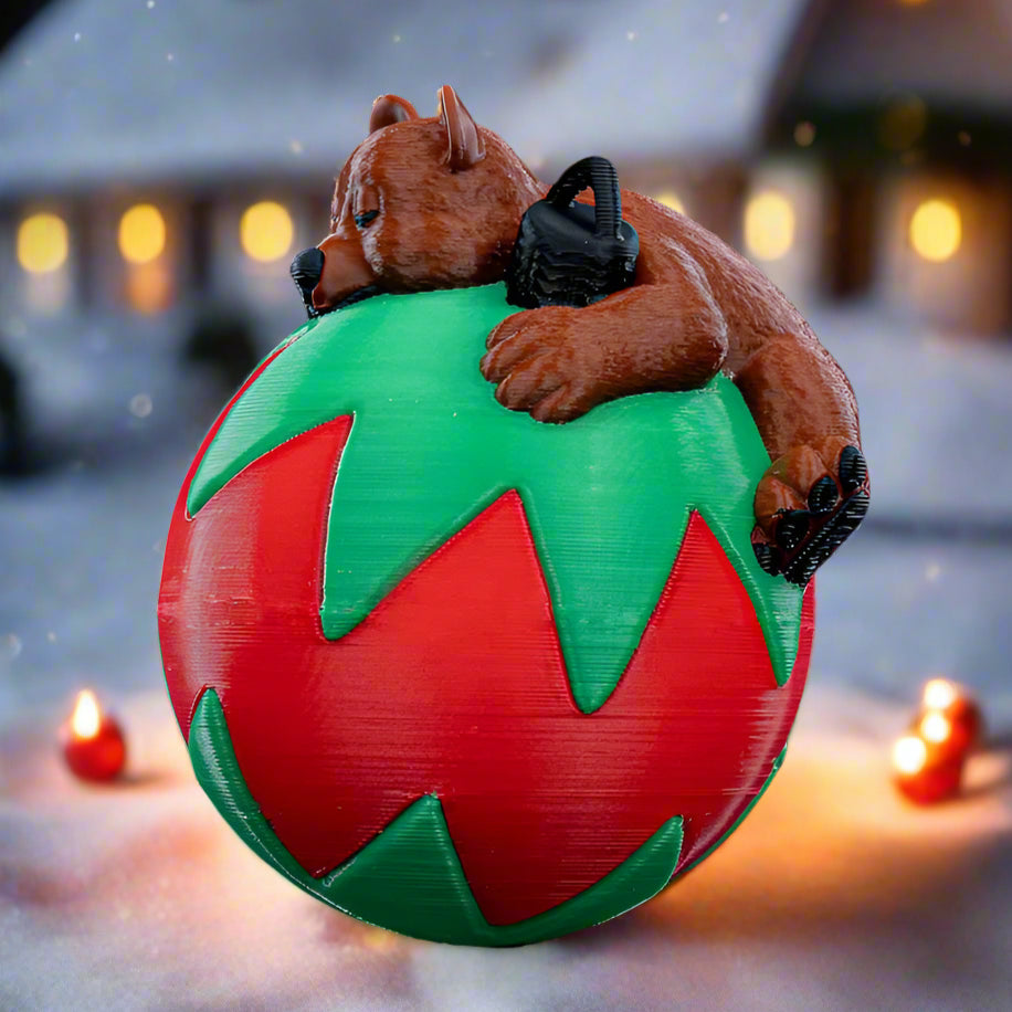 Peaceful sleeping bear inside a globe-shaped Christmas ornament