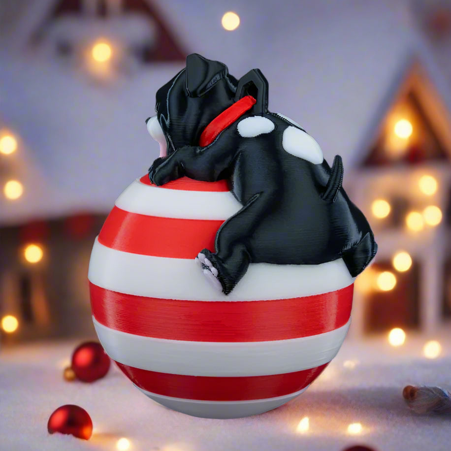 Close-up of Sleeping Dog Christmas decoration, highlighting the sleeping dog on the globe