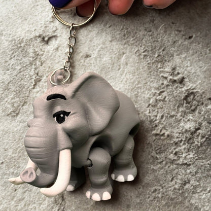 A small gift box lined with tissue paper contains the monkey keychain, ready to be gifted; the box is decorated with a jungle print, perfect for birthdays or special occasions.
