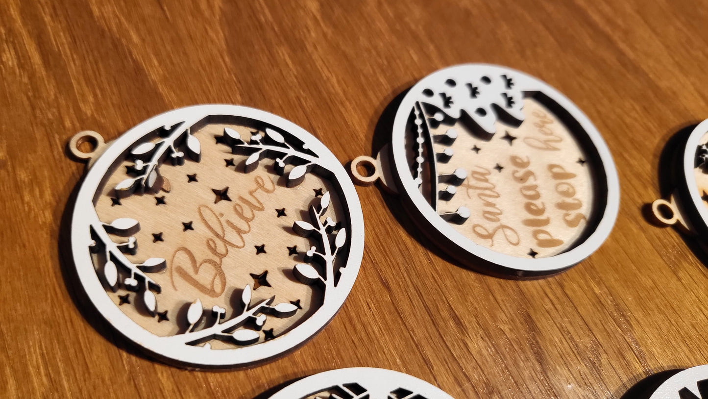 Close-up of a wooden ornament engraved with "Joy to the World" with a festive border.