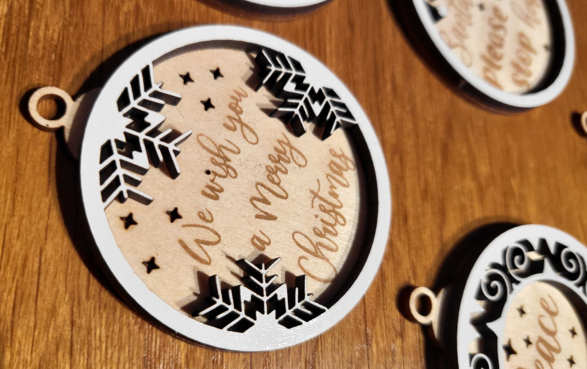 Handcrafted wooden ornament featuring a "Let it Snow" message and snowflakes