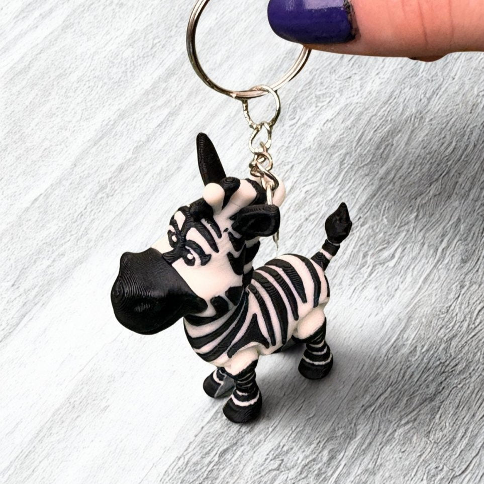 3D-printed ostrich keychain standing upright on a desk, doubling as a whimsical miniature decoration.