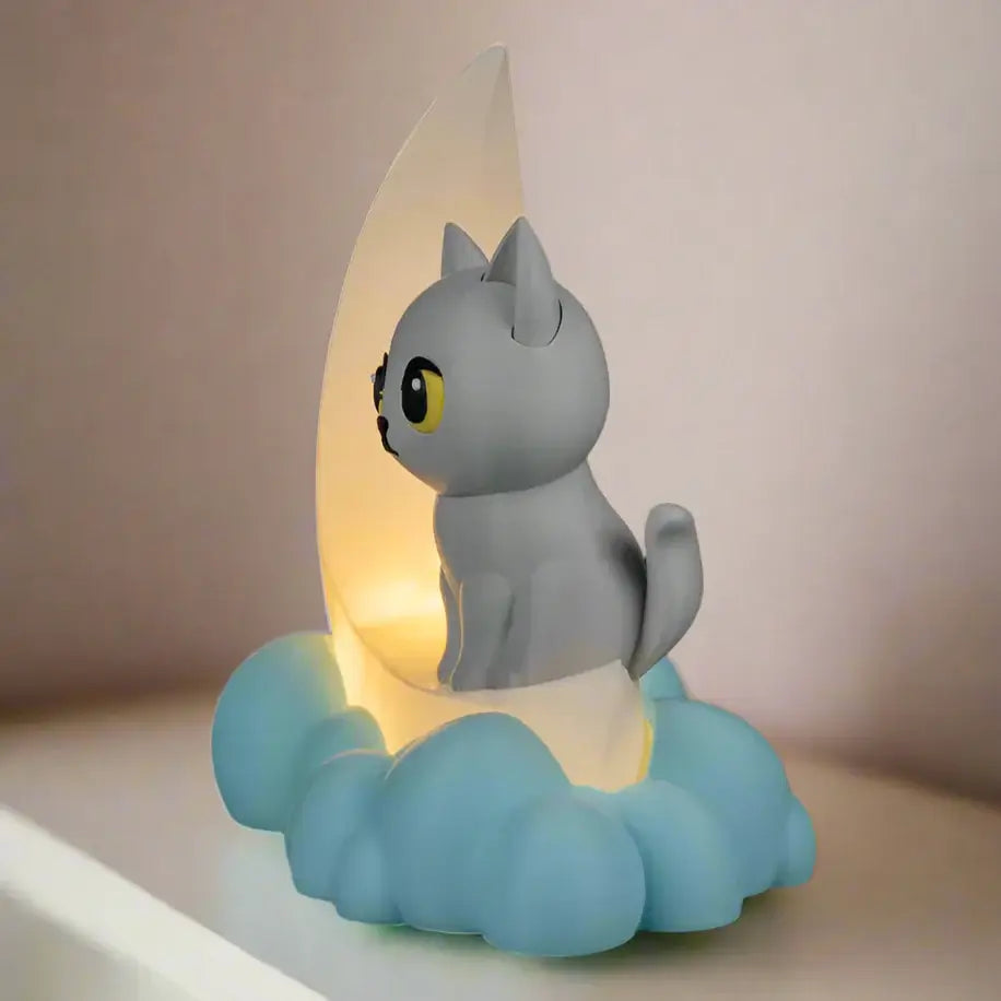 Cat-shaped night light with moon and cloud design on a black background