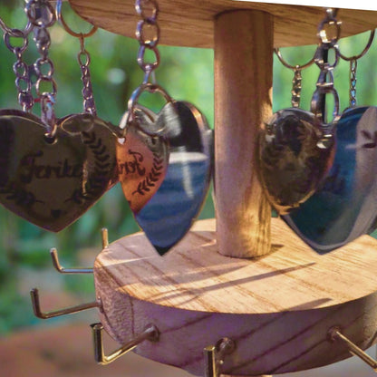 A close-up of a hand holding a heart-shaped engraved charm gently, with light falling on the message 'I carry you with me' – capturing emotion, loss, and a symbolic connection that lives on.