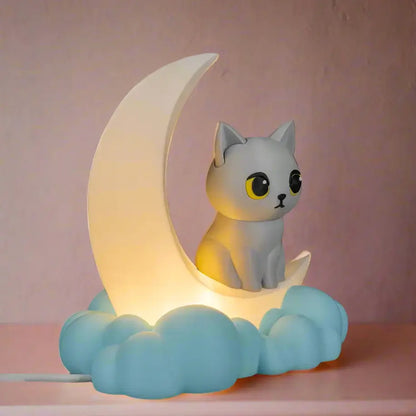 Cat-shaped night light on a crescent moon with cloud base against a pink background