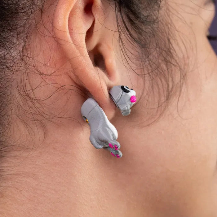A child’s backpack pocket half-open, revealing one quirky dog earring and a colorful gum wrapper next to it.