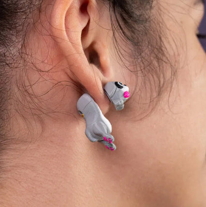 A child’s backpack pocket half-open, revealing one quirky dog earring and a colorful gum wrapper next to it.