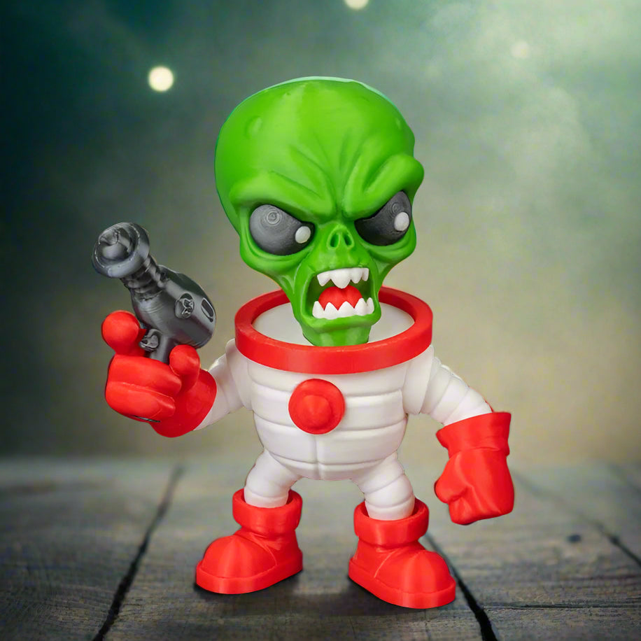 Toy figure of a green alien with a white suit and red accents on a black background