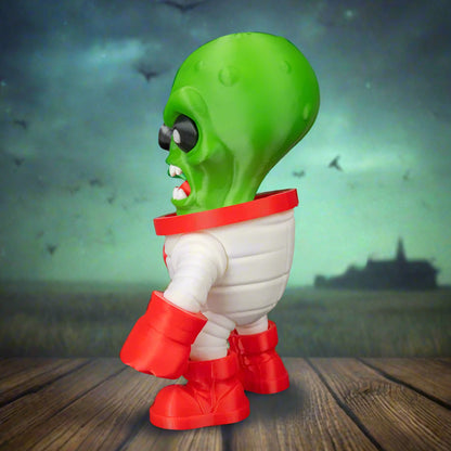 Toy figure of a green alien with red boots on a black background