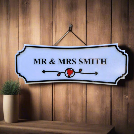 Decorative sign with 'MR & MRS SMITH' on a wooden wall.