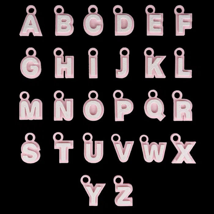Pink letter charms from A to Z on a black background