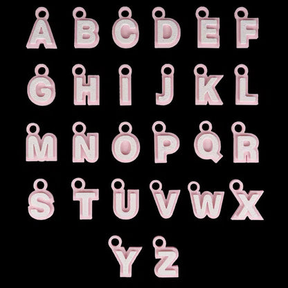 Pink letter charms from A to Z on a black background