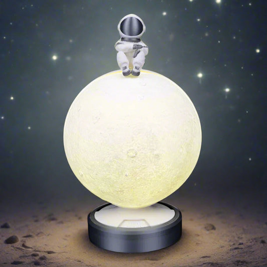 Close-up of the moon lamp showing a waxing crescent phase"
A detailed close-up of the moon lamp in waxing crescent mode. The textured lunar surface glows softly, while the name of the phase is illuminated on the lamp’s base. The little astronaut figure at the top adds a whimsical space-themed touch.