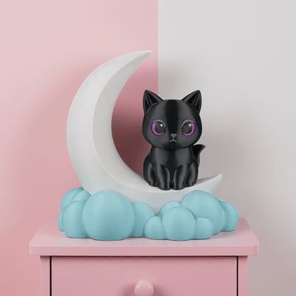 Black cat figurine on a white crescent moon with blue clouds against a pink background