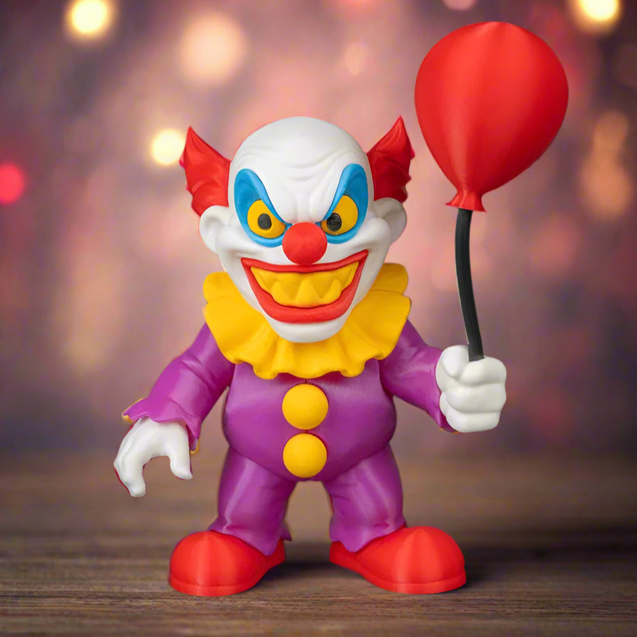 Colorful clown figurine with a red balloon on a black background
