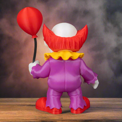 Toy figure of a clown with a red balloon on a black background