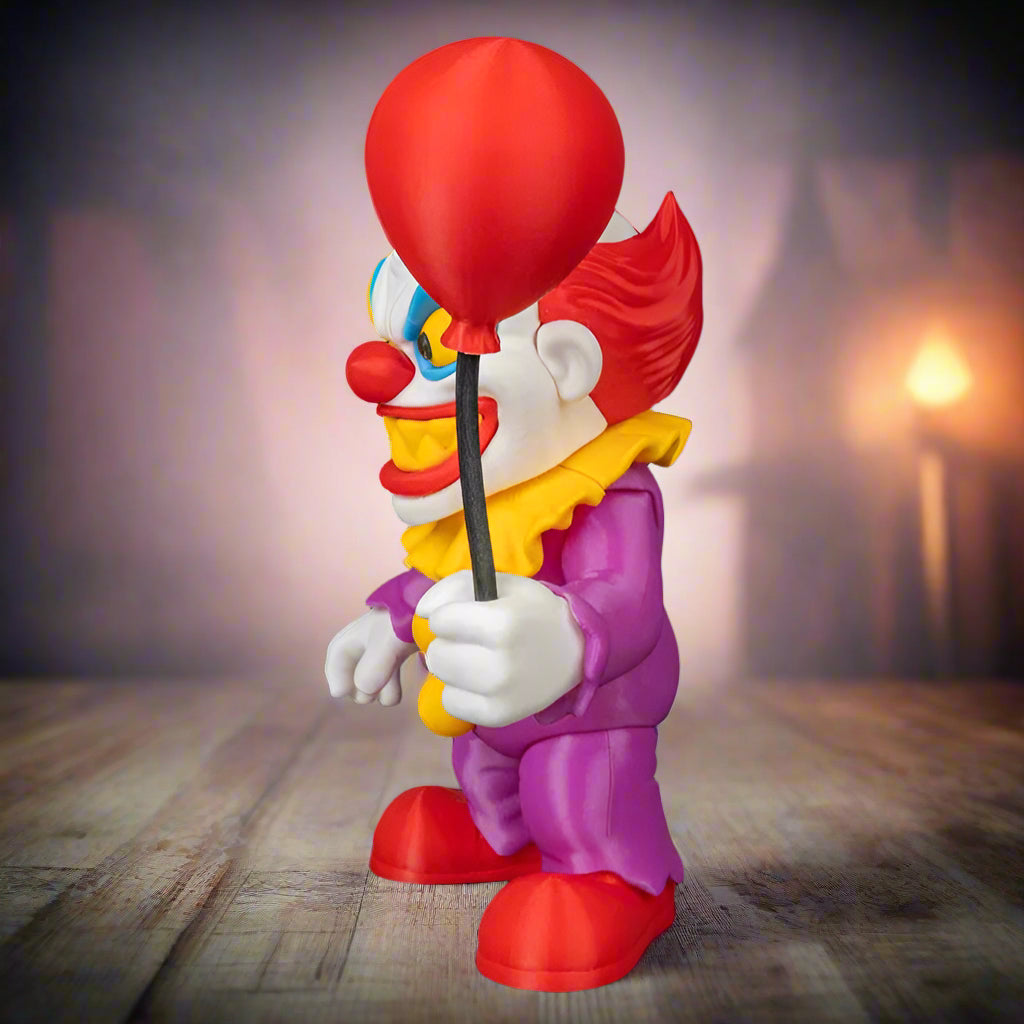 Colorful clown figurine holding a red balloon against a black background