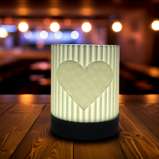 Decorative lamp with heart design on a wooden surface with a blurred background