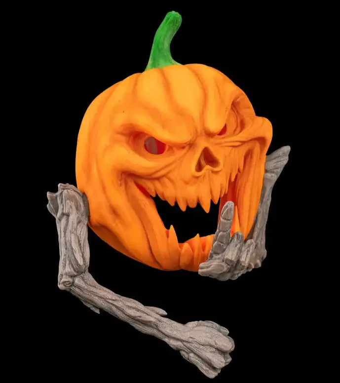 Halloween pumpkin with a carved face and skeleton hands on a black background