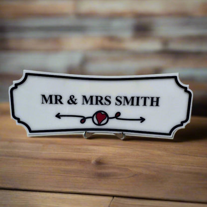 Decorative sign with 'MR & MRS SMITH' on a wooden surface