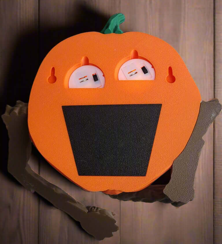 Pumpkin-shaped board with face design on a wooden background