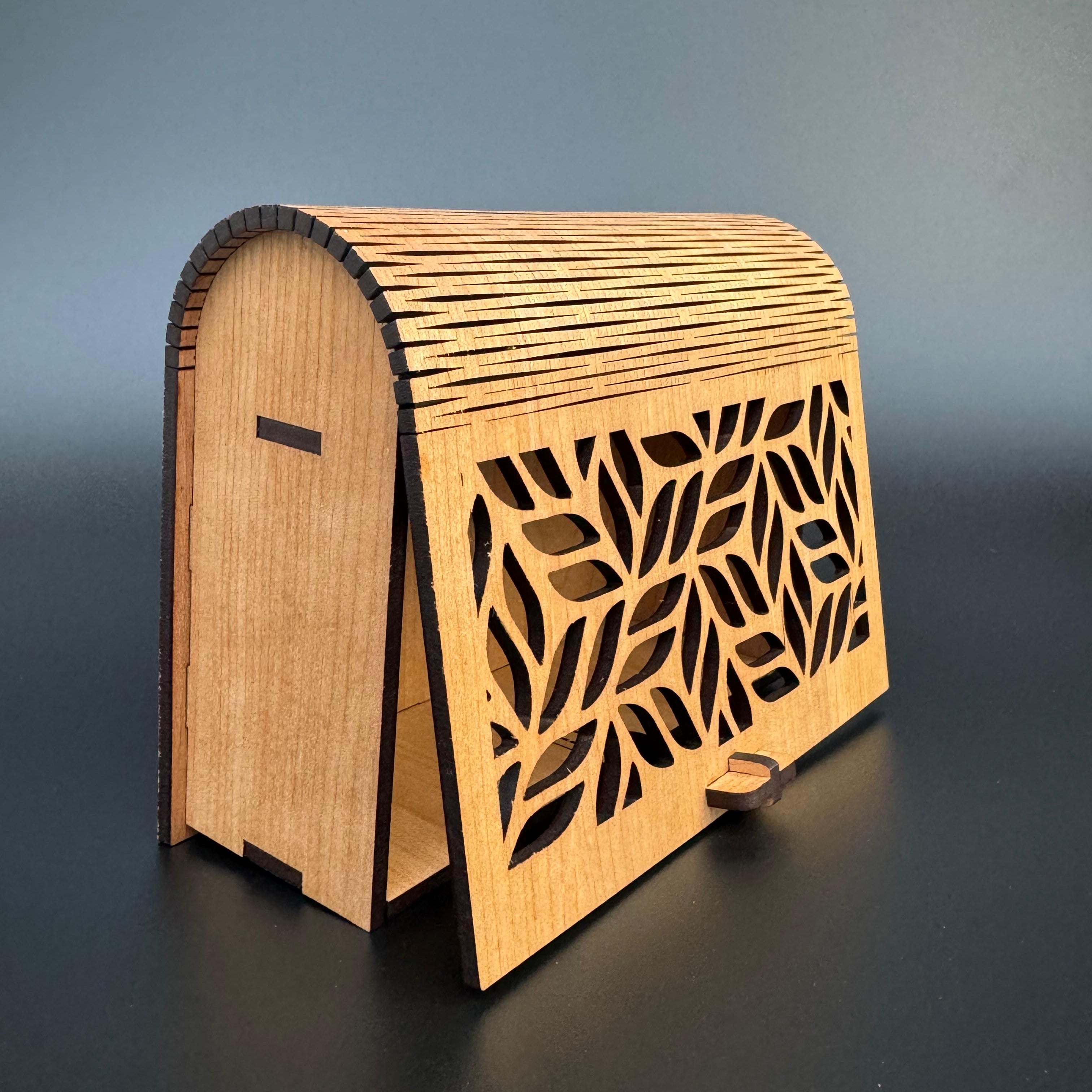 Wooden clutch bag with leaf pattern on a gray background